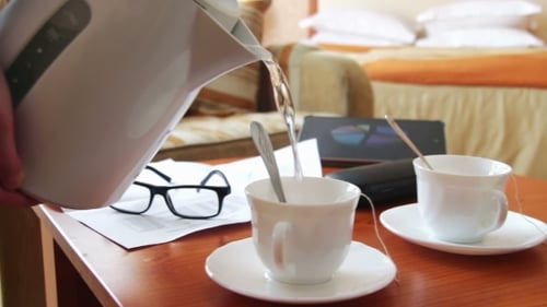 Woman Pours Tea For a Business Lunch.