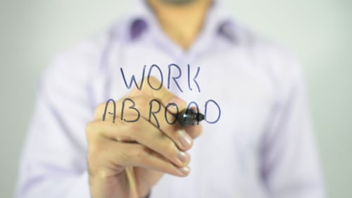 Man Writes 'Work Abroad' in Blue Marker