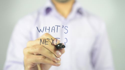 Person Writes What's Next On Clear Surface