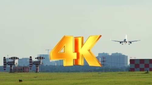 Passenger Airplane Landing on Green Airfield in Daytime