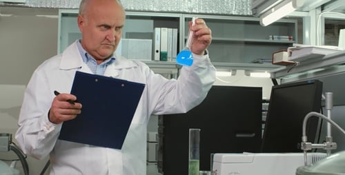 Scientist Working in Laboratory Taking Notes