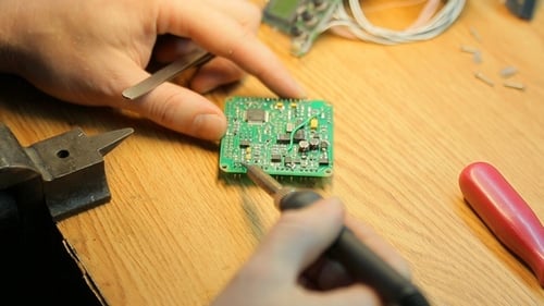 Close Up of Soldering Iron on Circuit Board
