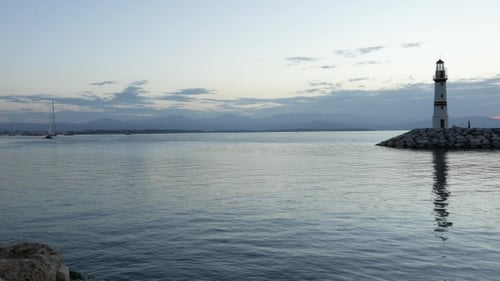 Breakwater And Lighthouse With Its Reflection