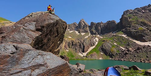 Hiker Exploring Scenic Mountain Lake Landscape