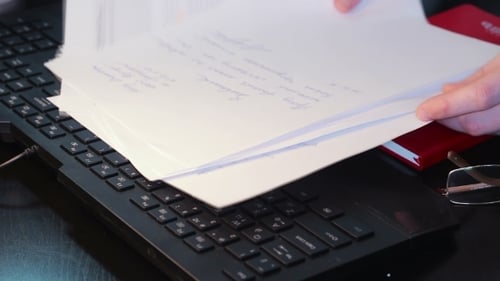 Flipping Through Documents on Keyboard at Workplace
