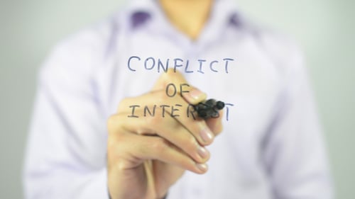 Hand Writes Conflict of Interest With Marker