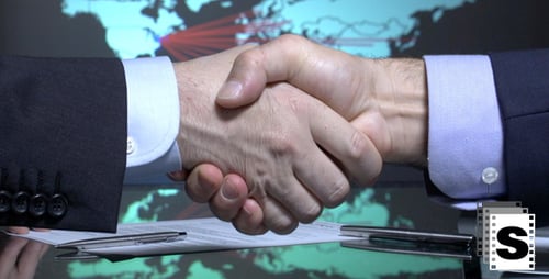 Business Handshake after Signing Contract in Modern Office