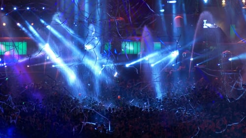Excited Crowd Dancing at Concert with Laser Lights