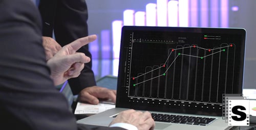 Corporate Men Reviewing Financial Data and Graphs