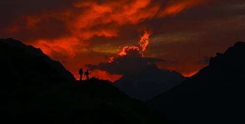 Mountains Silhouetted against a Fiery Red Sky