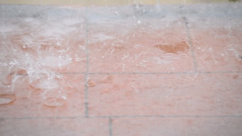 Rain Splashing on Tiled Surface during Daytime