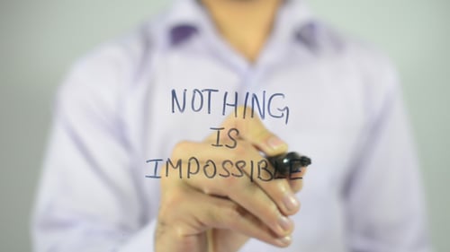 Man Writes "Nothing is Impossible" on Glass