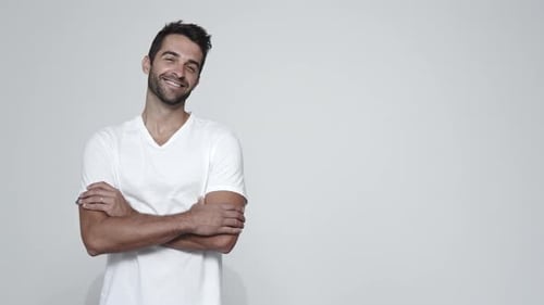 Handsome Man Poses Confidently Against White Background