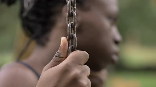 Woman Resting On Swing Holding Metal Chains