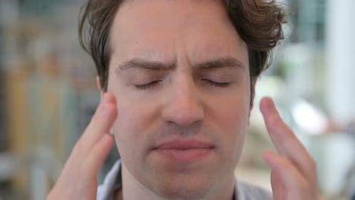 Face Close Up of Young Man Having Headache