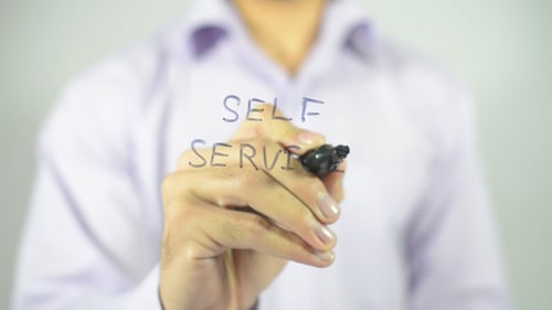 Man Writing Self Service with a Black Marker