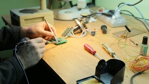 Hands Soldering Circuit Board Close Up
