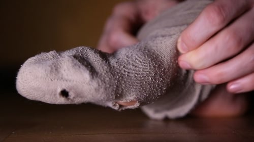Putting On Worn Sock with Holes, Close Up