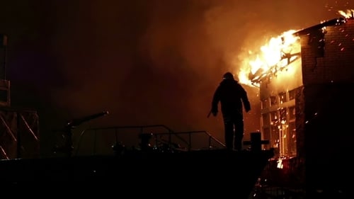 House On Fire. Conflagration. Fireman Fights Fire.