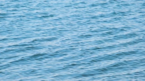 Closeup Seascape Surface of Blue Sea Water with Small Ripple Waves