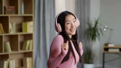 Enthusiastic Woman Dancing to Music at Home