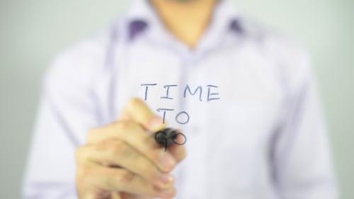 Figure Writes 'Time To' with a Marker