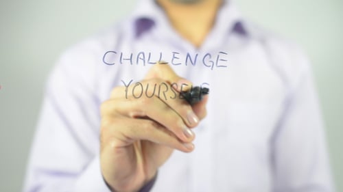 Hand Writes "Challenge Yourself" with Marker