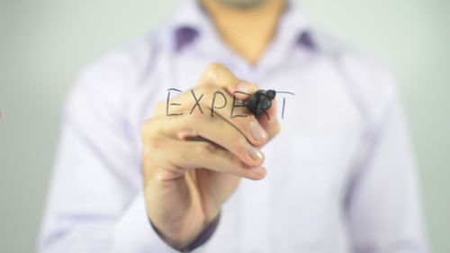 Arm Writes The Word Expert on Clear Surface