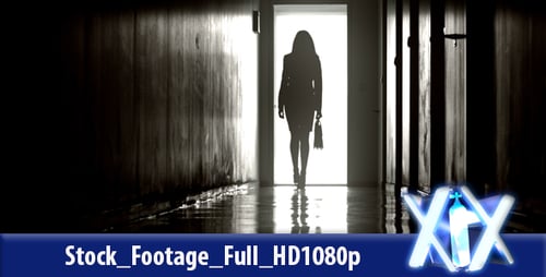 Woman Walking Toward Light at End of Hallway