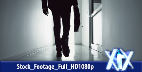 Silhouette Walking Down Dark Hallway