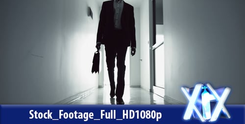 Silhouetted Business Figure Walking Down Hallway