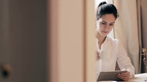 Woman Working with Tablet and Drinking Coffee Indoors