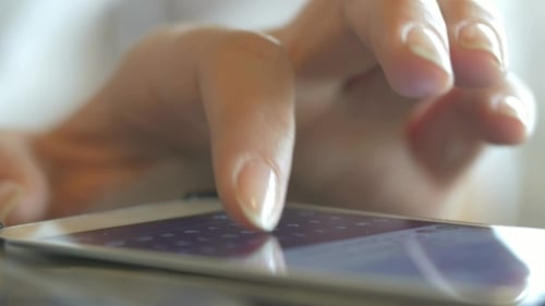 Using Smartphone And Eating Sushi Rolls