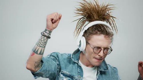 Smiling Man Dancing in Headphones at Studio. Guy Listening Music in Earphones