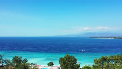 Wide above tourism shot of a white sandy paradise beach and aqua turquoise water background in colou