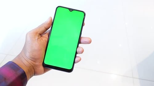 Close Up of Young Man Hand Using Smart Phone with Green Screen