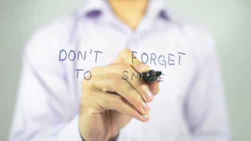 Hand Writes 'Don't Forget To Smile' Message