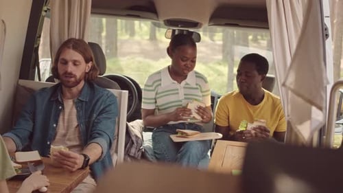 Multiethnic Friends Eating Homemade Sandwiches in House on Wheels