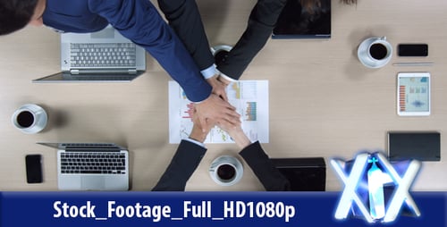 Business Colleagues Putting Hands Together in Office