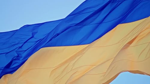 Flag Waving in the Wind Against Blue Sky