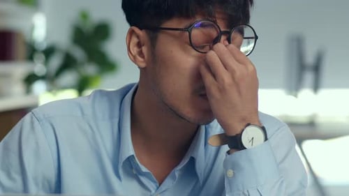 Asian creative man stress while working on laptop.