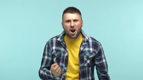 Angry Man Shouting and Raising his Fist
