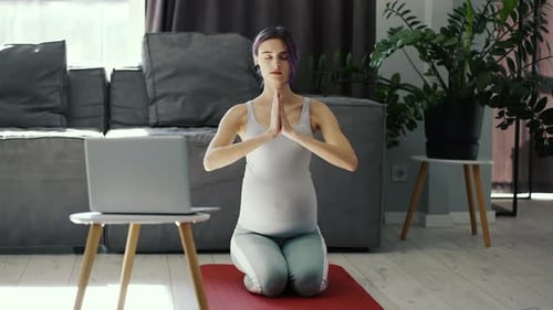 Pregnant Woman Doing Yoga Exercise at Home