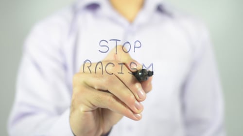 Writing 'Stop Racism' Message on Transparent Surface