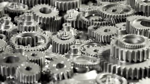 Seamless loop animation of a bunch of dark metallic gears laying on the heap.