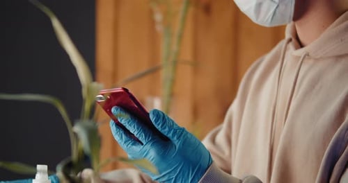 Phone Disinfecting During Pandemic, Masked Person Cleaning Device