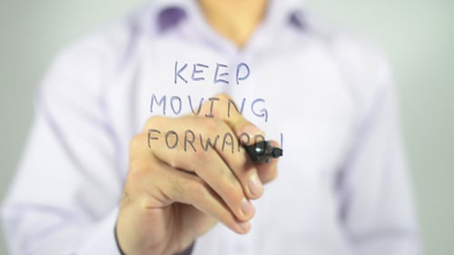 Hand Writes 'Keep Moving Forward' Message