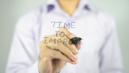 Hand Writes Time to Improve on Clear Surface