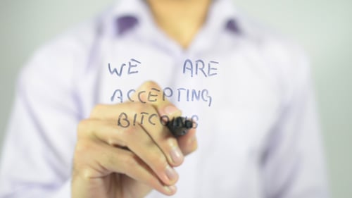 Accepting Bitcoin Written on Glass by Man