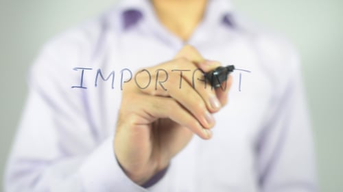 Person Writing the Word Important with Marker